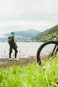Man overlooking a lake with backpack