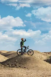 Guy looking afar from a hill on an MTB
