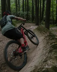 guy on mtb speeding down the berm
