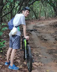Tired guy on mountain bike walking
